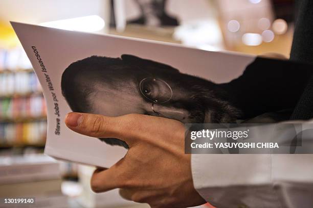 Young man takes a biography of the late "Apple" co-founder Steve Jobs, at a bookshop in Sao Paulo, Brazil, on October 24, 2011. The eagerly awaited...