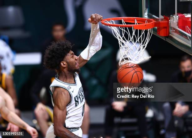 Aaron Henry of the Michigan State Spartans dunks the ball in the first half against the Iowa Hawkeyes at Breslin Center on February 13, 2021 in East...