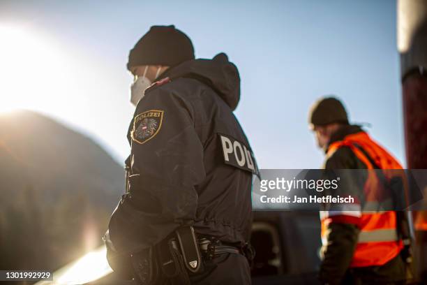 Members of Austria's border police and the Austrian army speak to a driver at a checkpoint on the border to Germany following new border policies in...