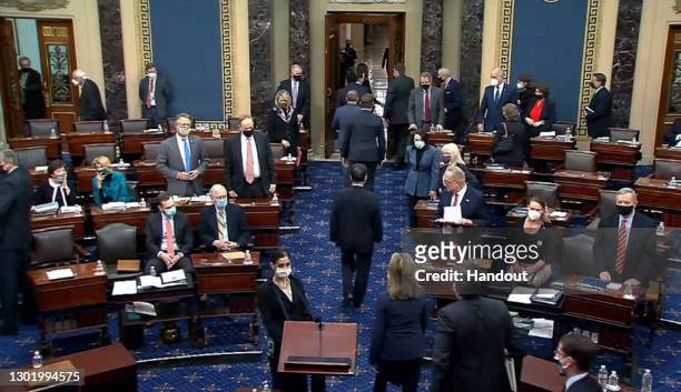 In this screenshot taken from a congress.gov webcast, the House impeachment managers are escorted out after the Senate voted 57-43 to acquit on the...
