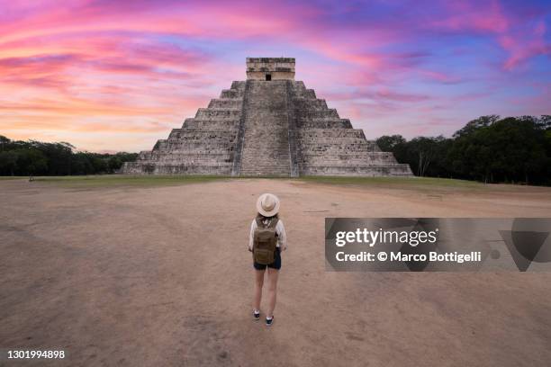 woman admiring chichen itza's kukulkan pyramid at sunrise, mexico - famous women in history stock pictures, royalty-free photos & images
