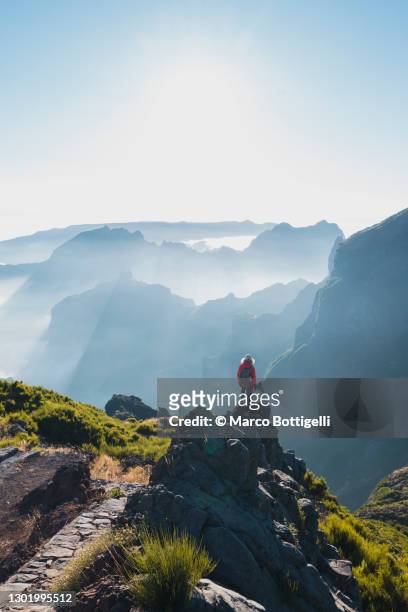 woman admiring the view from the top of a mountain in madeira - atlantic islands ストックフォトと画像
