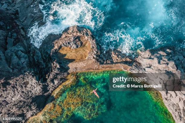 woman relaxing in a natural pool - madeira stock pictures, royalty-free photos & images