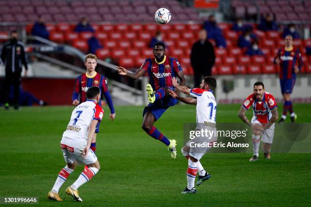 Samuel Umtiti of FC Barcelona battles for possession with Luis Rioja of Deportivo Alaves during the La Liga Santander match between FC Barcelona and...