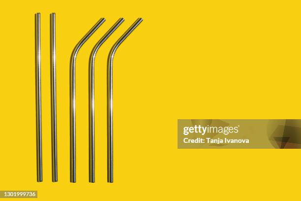 metal straws on yellow background. zero waste concept. flat lay, top view, copy space. - straw stock photos et images de collection