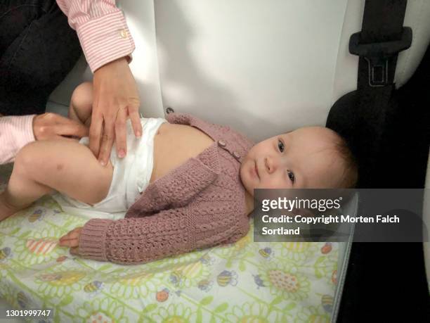 changing baby's diaper in arboga, sweden - arboga stock pictures, royalty-free photos & images