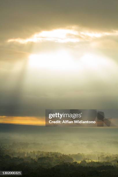 sunbeam through overcast sky - genomborra bildbanksfoton och bilder