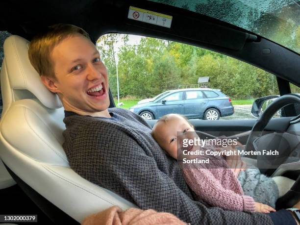 daddy and baby sitting on the driver's seat in arboga, sweden - arboga stock pictures, royalty-free photos & images