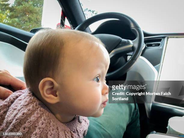 baby sitting on the driver's seat in arboga, sweden - arboga stock pictures, royalty-free photos & images