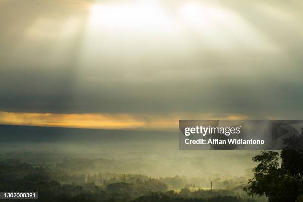 sunbeam through overcast sky - penetrating stock pictures, royalty-free photos & images