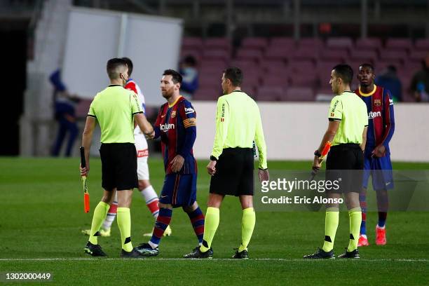 Lionel Messi of FC Barcelona interacts with the Match Official's following the La Liga Santander match between FC Barcelona and Deportivo Alavés at...