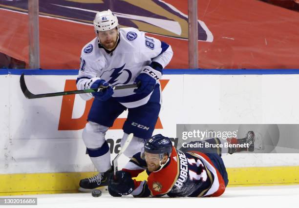 Erik Cernak of the Tampa Bay Lightning and Jonathan Huberdeau of the Florida Panthers pursue the puck during the first period at the BB&T Center on...