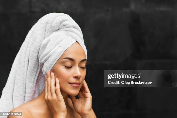 woman portrait after beauty and spa treatment on dark background - physiotherapy asian stock pictures, royalty-free photos & images