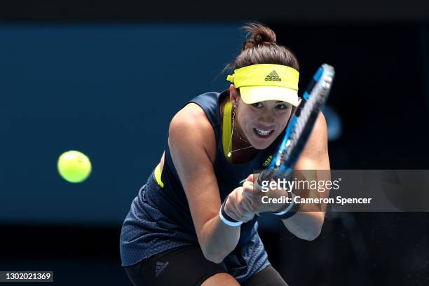 Garbine Muguruza of Spain plays a backhand in her Women's Singles fourth round match against Naomi Osaka of Japan during day seven of the 2021...