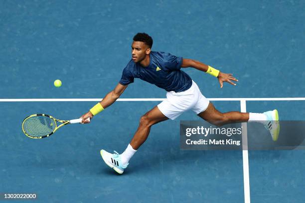 Felix Auger-Aliassime of Canada plays a forehand in his Men's Singles fourth round match against Aslan Karatsev of Russia during day seven of the...