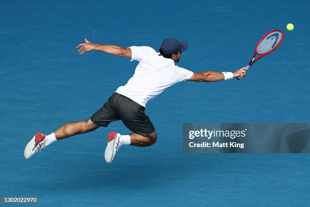 Aslan Karatsev of Russia plays a backhand in his Men's Singles fourth round match against Felix Auger-Aliassime of Canada during day seven of the...