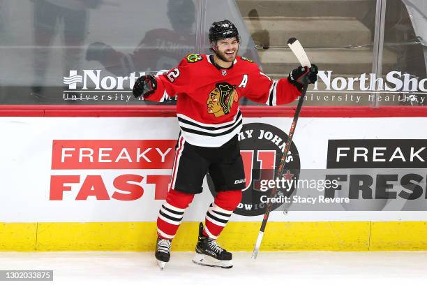 Alex DeBrincat of the Chicago Blackhawks celebrates after scoring the game winning goal in overtime against the Columbus Blue Jackets at the United...