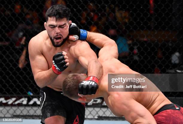 Ian Heinisch punches Kelvin Gastelum in their middleweight fight during the UFC 258 event at UFC APEX on February 13, 2021 in Las Vegas, Nevada.