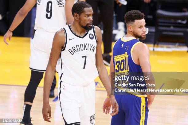 Golden State Warriors guard Stephen Curry and Brooklyn Nets forward Kevin Durant in the first quarter of an NBA game at Chase Center, Saturday, Feb....