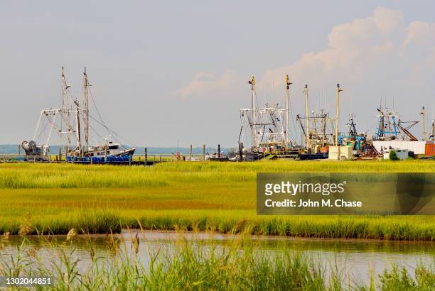 commercial fishing boats, tidal marsh, cape may, nj - tidal marsh stock pictures, royalty-free photos & images