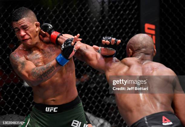 Kamaru Usman of Nigeria punches Gilbert Burns of Brazil in their UFC welterweight championship fight during the UFC 258 event at UFC APEX on February...