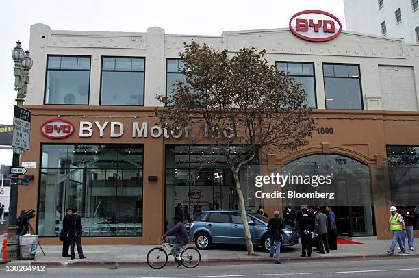 People stand outside during the grand opening of BYD Co.'s North American headquarters in Los Angeles, California, U.S., on Monday, Oct. 24, 2011....