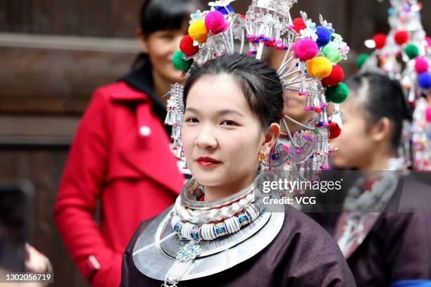 Bridesmaid attends a parade to send outmarried women back to their parents' homes at Sanjiang Dong Autonomous County on February 14, 2021 in Liuzhou,...