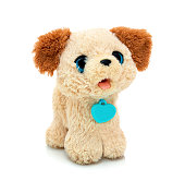 Dog plushie doll isolated on white background with shadow reflection. Playful bright brown puppy toy. Plush stuffed puppet on white backdrop. Fluffy toy for children. Cute furry plaything for kids.
