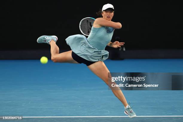 Iga Swiatek of Poland plays a forehand in her Women's Singles fourth round match against Simona Halep of Romania during day seven of the 2021...