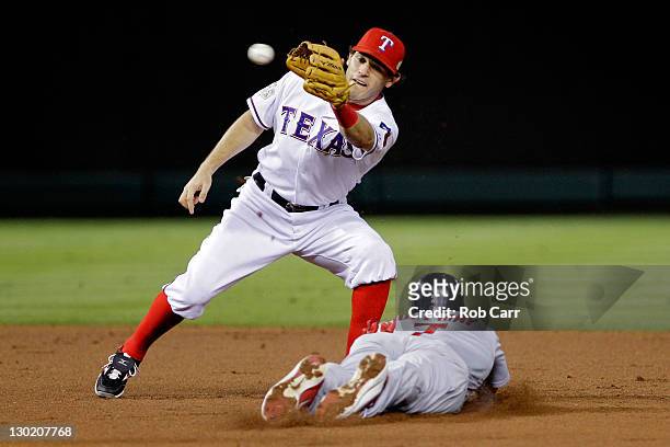 Matt Holliday of the St. Louis Cardinals slides into second base safely ahead of the tag by Ian Kinsler of the Texas Rangers after a wild pitch in...