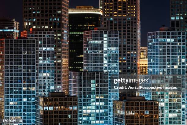 the exterior of skyscrapers in beijing at night - skyscraper window stock pictures, royalty-free photos & images