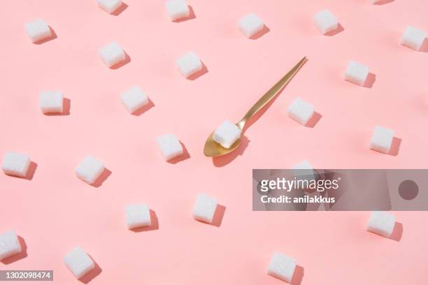 geometry pattern made of white sugar cubes on pink background - craving food stock pictures, royalty-free photos & images