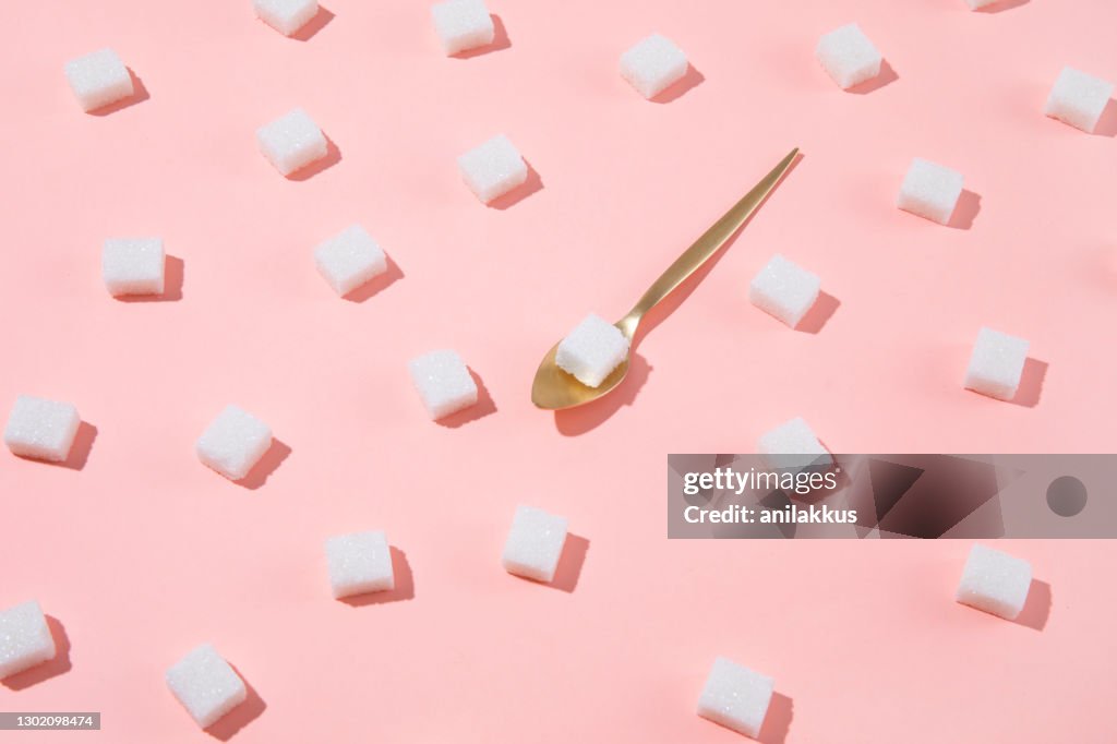 Geometry Pattern Made of White Sugar Cubes on Pink Background