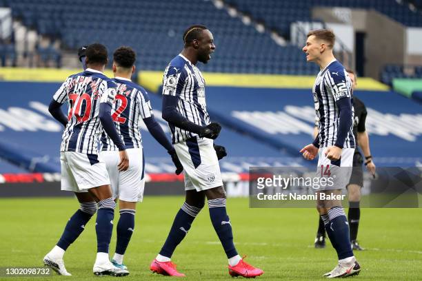 Mbaye Diagne of West Bromwich Albion celebrates with team mate Conor Townsend after scoring their side's first goal during the Premier League match...