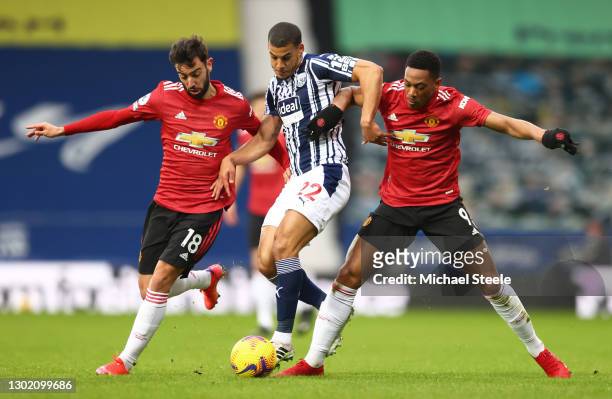 Bruno Fernandes and Anthony Martial of Manchester United battle for possession with Lee Peltier of West Bromwich Albion during the Premier League...