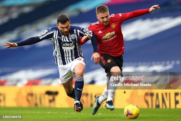 Luke Shaw of Manchester United and Robert Snodgrass of West Bromwich Albion battle for possession during the Premier League match between West...