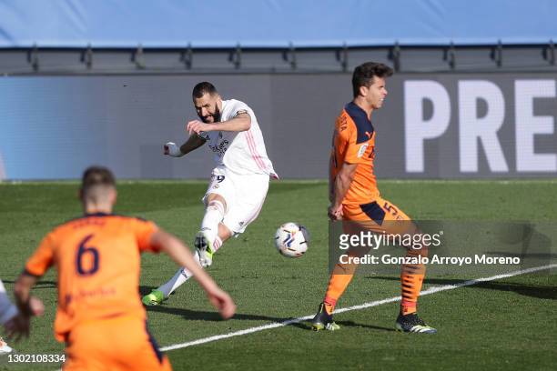 Karim Benzema of Real Madrid scores their side's first goal during the La Liga Santander match between Real Madrid and Valencia CF at Estadio Alfredo...