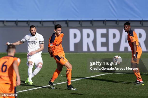 Karim Benzema of Real Madrid scores their side's first goal during the La Liga Santander match between Real Madrid and Valencia CF at Estadio Alfredo...