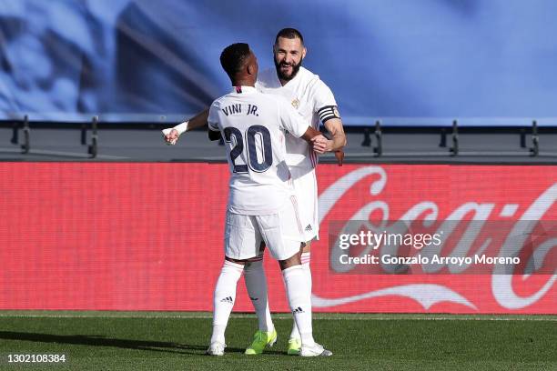 Karim Benzema of Real Madrid celebrates with team mate Vinicius Junior after scoring their side's first goal during the La Liga Santander match...