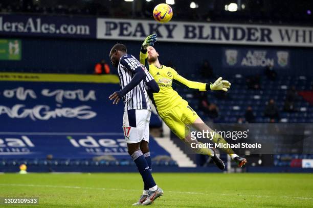 David de Gea of Manchester United makes a save from the head of Mbaye Diagne of West Bromwich Albion during the Premier League match between West...
