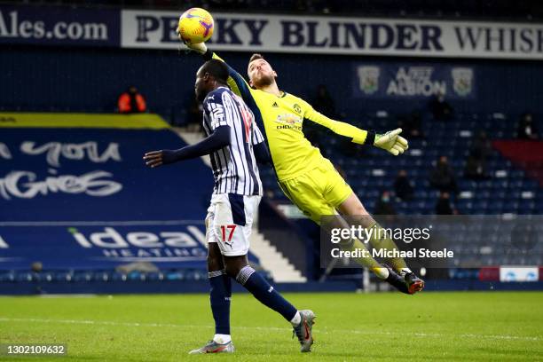 David de Gea of Manchester United makes a save from the head of Mbaye Diagne of West Bromwich Albion during the Premier League match between West...