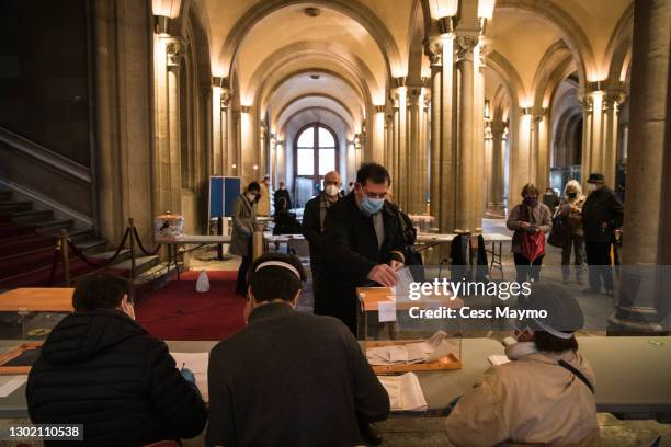 People vote at the electoral college of the Universitat de Barcelona, during Catalonia's Regional Elections on February 14, 2021 in Barcelona, Spain....