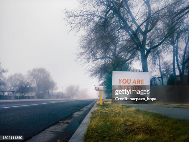 "you are needed" sign in a small town on a foggy morning. - suicide stock pictures, royalty-free photos & images