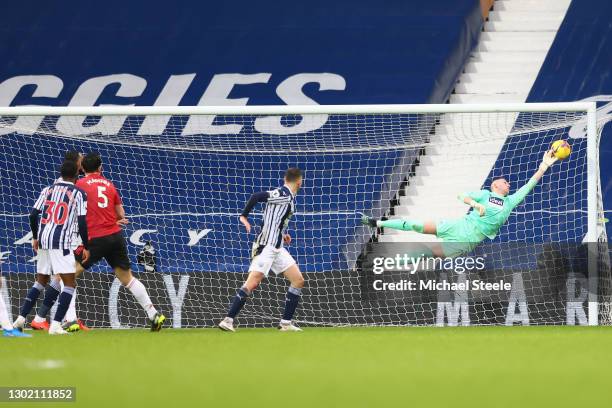 Sam Johnstone of West Bromwich Albion makes a save from the shot of Harry Maguire of Manchester United during the Premier League match between West...