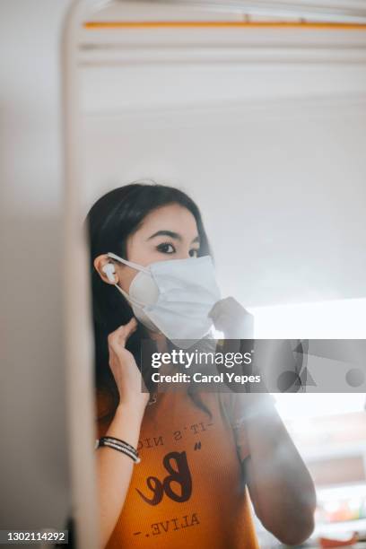 mirror reflexion of teenager girl with  two protective face mask - medicamento antiviral imagens e fotografias de stock