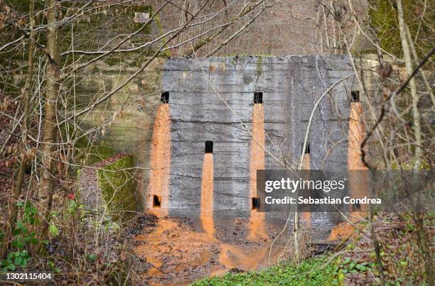 forest abstract old dam, water from sluice, outside down. - abflussrinne stock-fotos und bilder