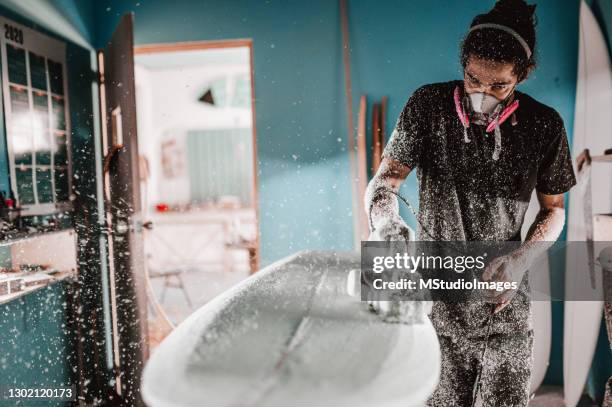 worker sanding surfboard - surfboard building stock pictures, royalty-free photos & images