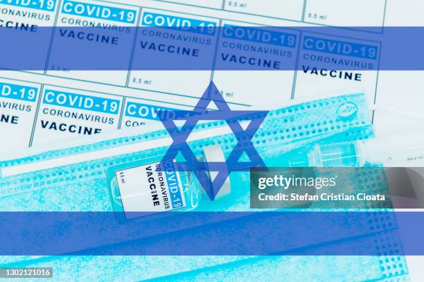 israeli flag over vaccine and face protective mask - association of religion data archives stock pictures, royalty-free photos & images