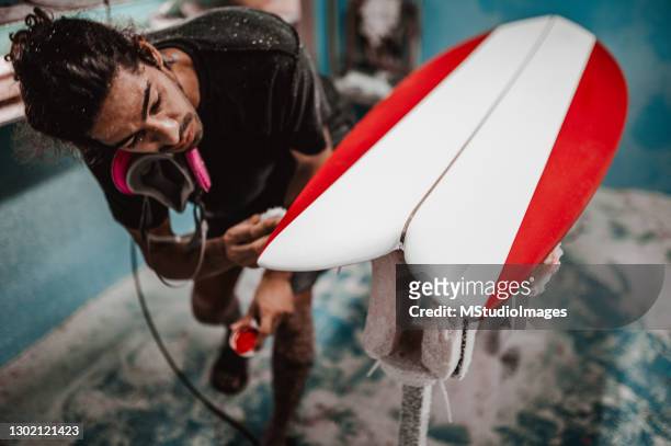 manual worker painting details on the surfboard - trabajador manual stock pictures, royalty-free photos & images