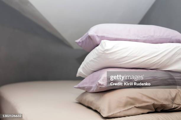 pillows piled on a bed - travesseiro imagens e fotografias de stock